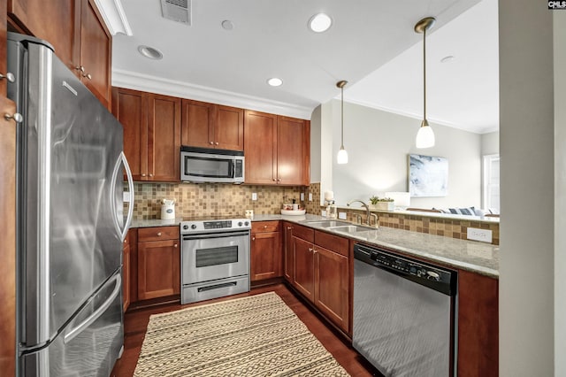 kitchen featuring appliances with stainless steel finishes, backsplash, hanging light fixtures, ornamental molding, and sink