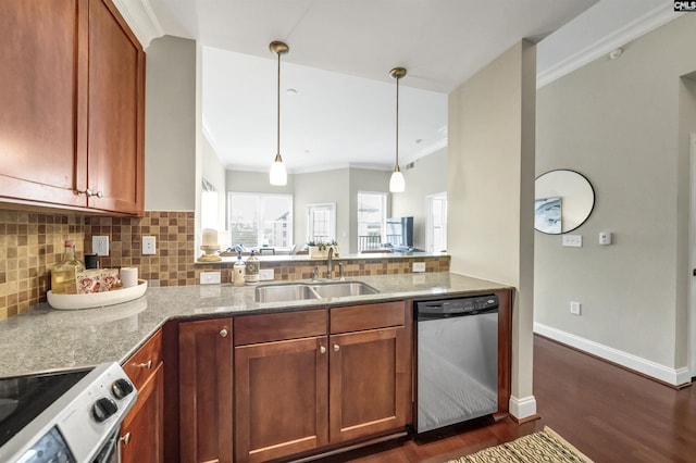 kitchen with appliances with stainless steel finishes, sink, light stone counters, and pendant lighting