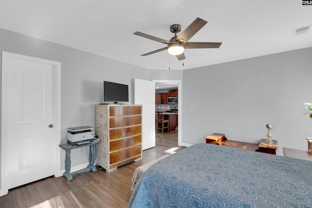 bedroom featuring ceiling fan and hardwood / wood-style flooring