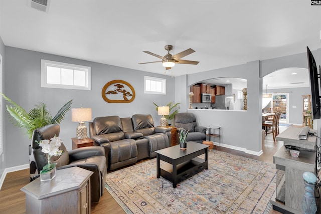 living room featuring ceiling fan and light hardwood / wood-style floors