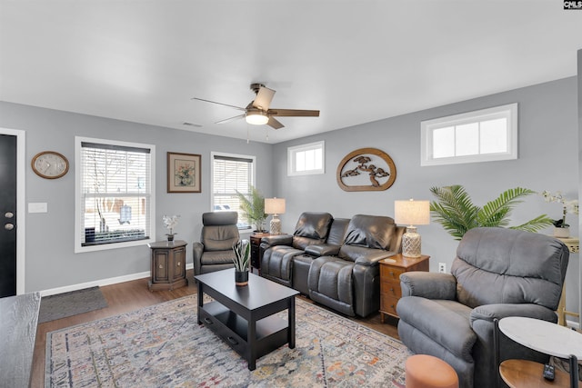 living room featuring ceiling fan and light hardwood / wood-style flooring