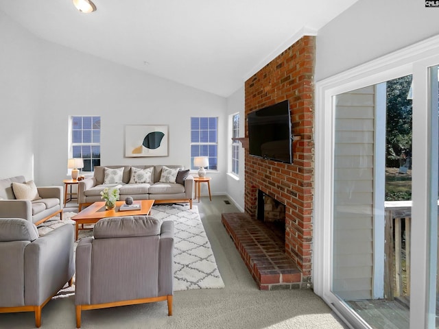 living room with vaulted ceiling and a fireplace