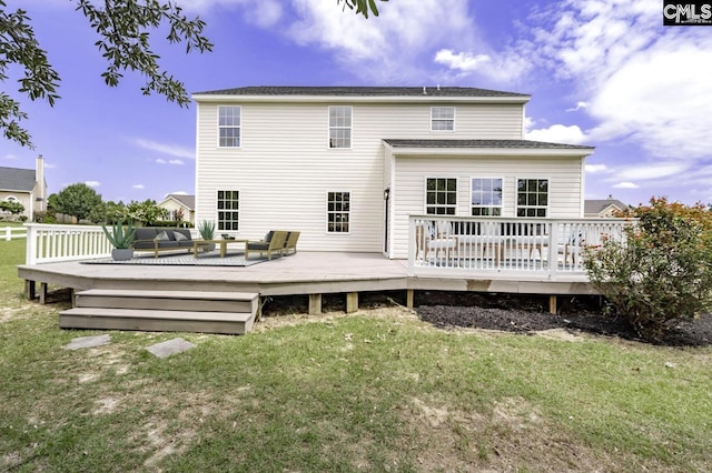 back of property featuring a yard, outdoor lounge area, and a wooden deck