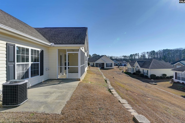 view of yard with cooling unit, a sunroom, and a patio