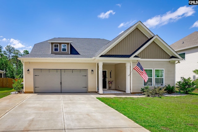 craftsman-style house with a garage and a front lawn