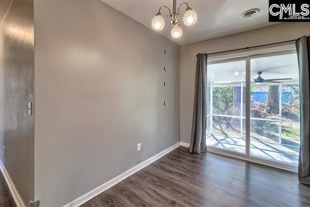 spare room featuring ceiling fan with notable chandelier and dark hardwood / wood-style floors