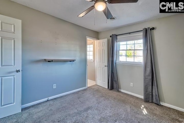 unfurnished bedroom featuring ceiling fan and carpet floors