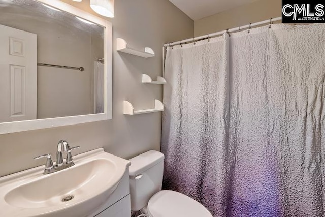 bathroom with toilet and vanity