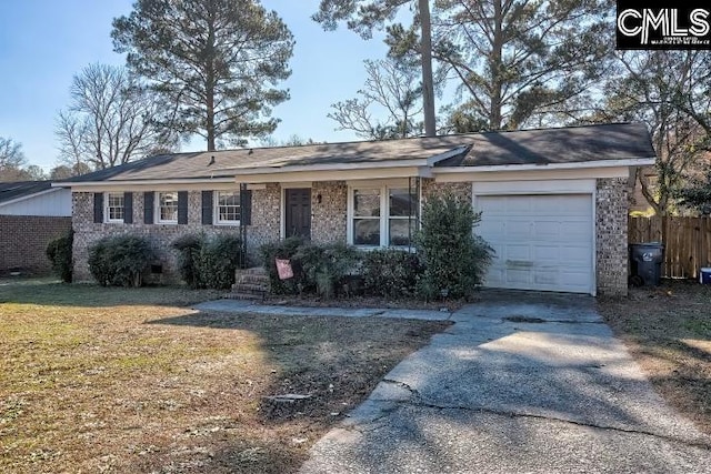 ranch-style home with a front yard and a garage