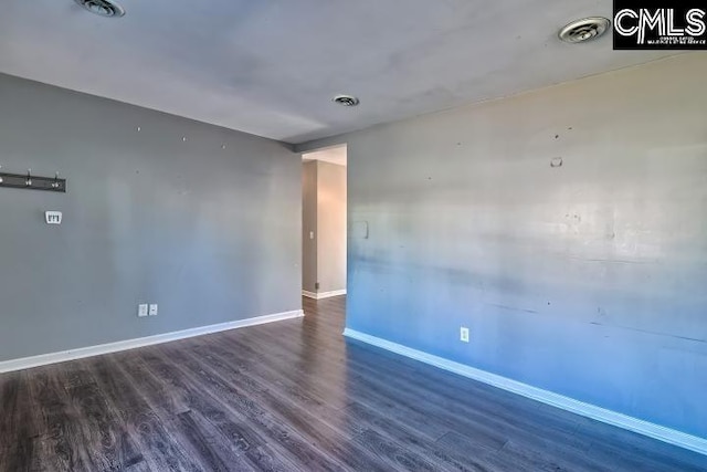 spare room with dark wood-type flooring