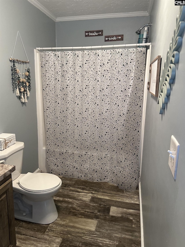 bathroom with toilet, a textured ceiling, crown molding, and wood-type flooring