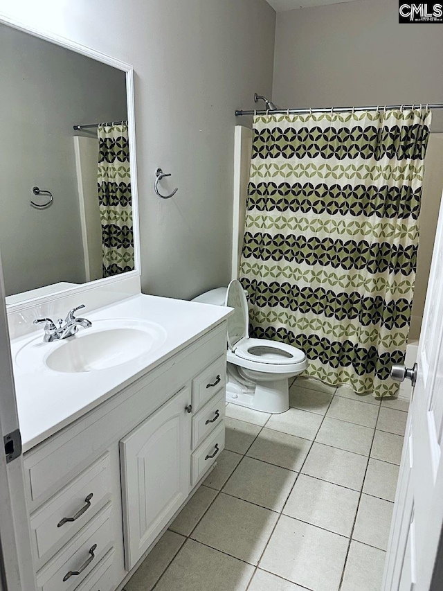 bathroom featuring toilet, vanity, and tile patterned floors