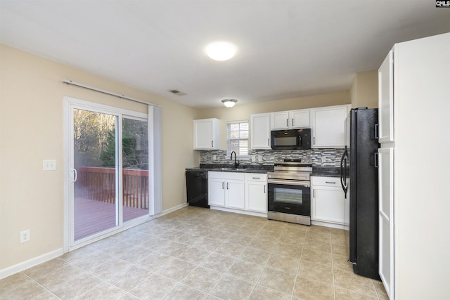 kitchen featuring light tile patterned floors, white cabinetry, backsplash, black appliances, and sink