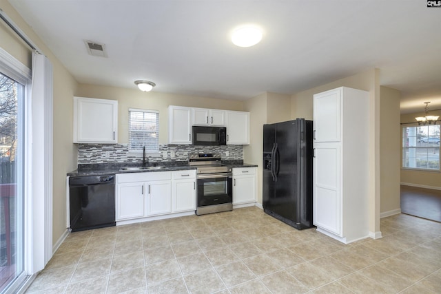 kitchen featuring white cabinets, black appliances, decorative backsplash, sink, and a chandelier