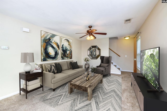 carpeted living room featuring ceiling fan