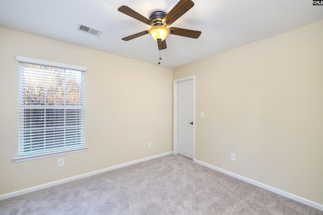 unfurnished room featuring ceiling fan and light colored carpet