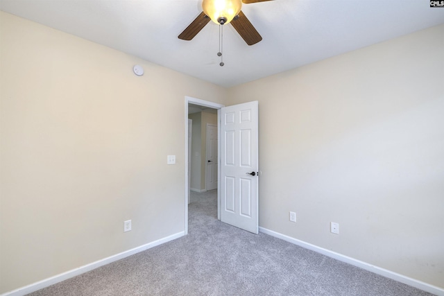 unfurnished room featuring ceiling fan and carpet