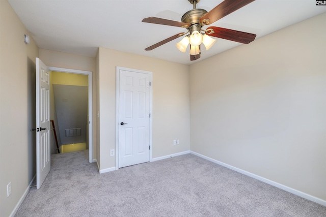 unfurnished bedroom featuring ceiling fan and light carpet