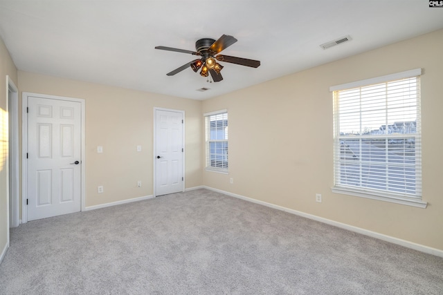 carpeted empty room featuring ceiling fan