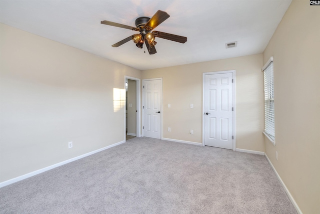 unfurnished bedroom featuring ceiling fan and light carpet