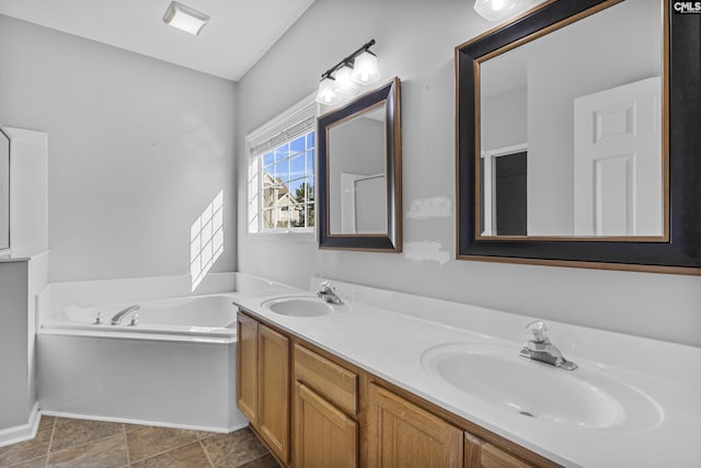 bathroom with vanity and a tub