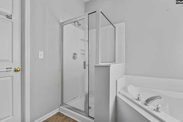 bathroom featuring independent shower and bath and tile patterned flooring