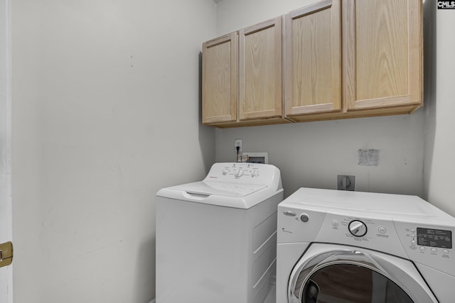 washroom with cabinets and separate washer and dryer