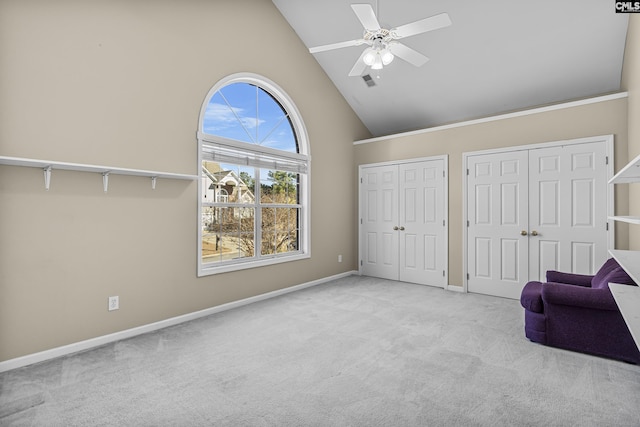 unfurnished room featuring light carpet, ceiling fan, and high vaulted ceiling