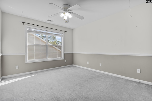 carpeted empty room featuring ceiling fan