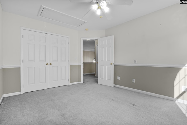 unfurnished bedroom with ceiling fan, a closet, and light colored carpet