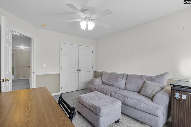 living room featuring ceiling fan and light carpet