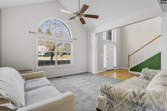 living room featuring ceiling fan, lofted ceiling, and decorative columns