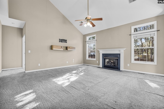 unfurnished living room with high vaulted ceiling, ceiling fan, and carpet floors