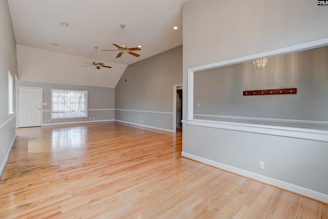 interior space with baseboards, ceiling fan, wood finished floors, high vaulted ceiling, and recessed lighting