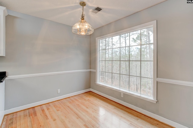 unfurnished room with wood-type flooring and plenty of natural light