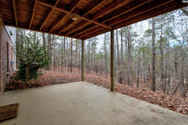 view of patio with a wooded view