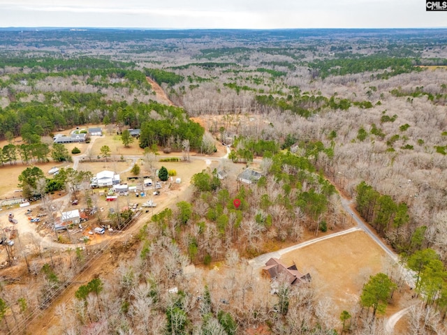 bird's eye view featuring a wooded view