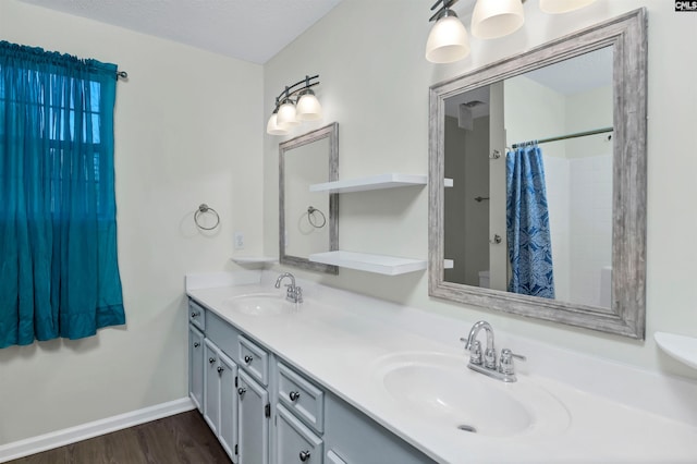 bathroom with toilet, vanity, hardwood / wood-style floors, a shower with curtain, and a textured ceiling