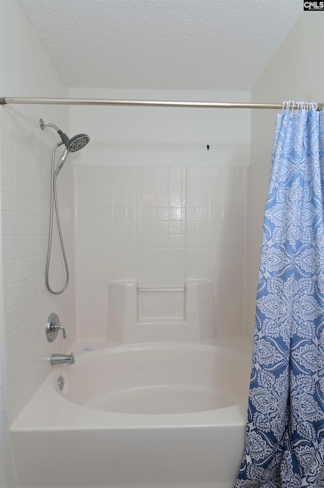 bathroom featuring a textured ceiling and shower / tub combo