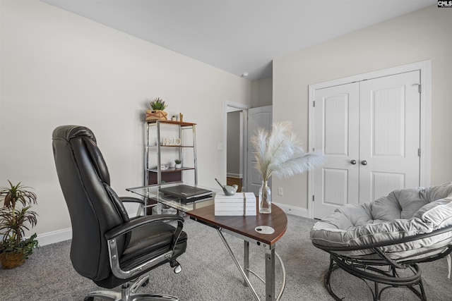 carpeted office space featuring baseboards