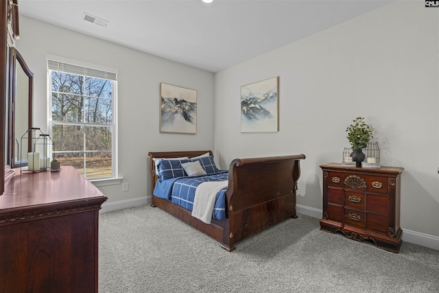 carpeted bedroom with multiple windows, visible vents, and baseboards