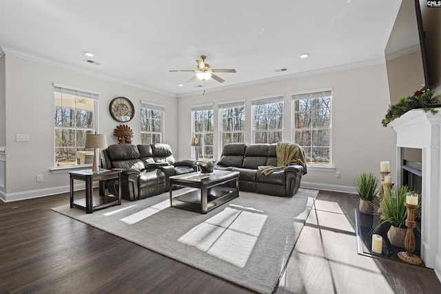 living room with ceiling fan, crown molding, baseboards, and wood finished floors