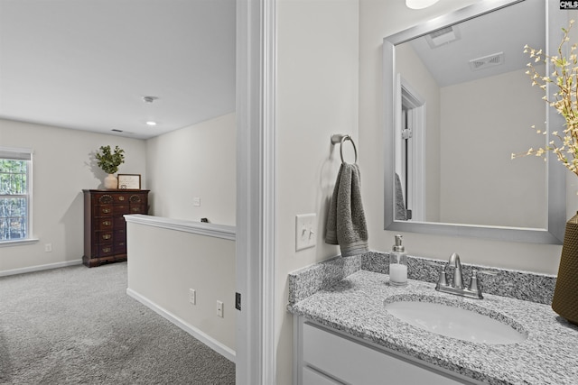 bathroom featuring visible vents, vanity, and baseboards