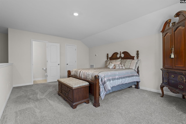 bedroom featuring lofted ceiling, baseboards, visible vents, and light colored carpet