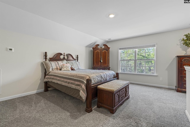 bedroom featuring light carpet, visible vents, baseboards, and vaulted ceiling