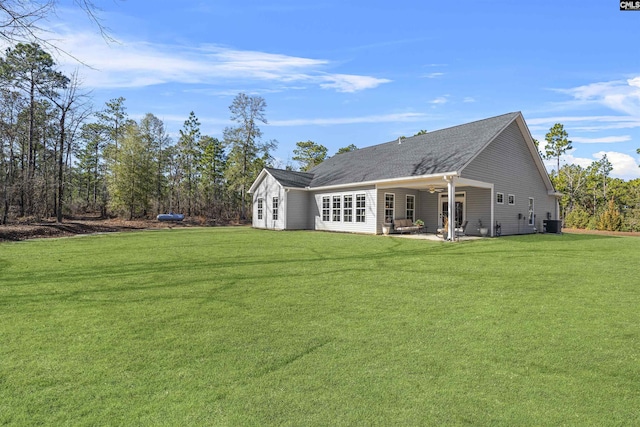 back of house featuring a ceiling fan, a patio area, a yard, and central AC unit