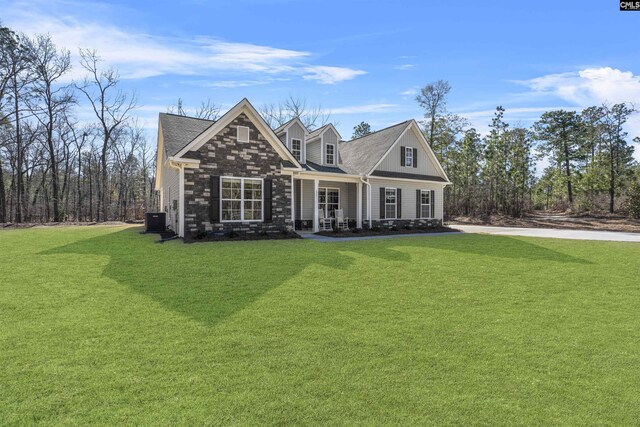 view of front of property with central AC unit and a front yard