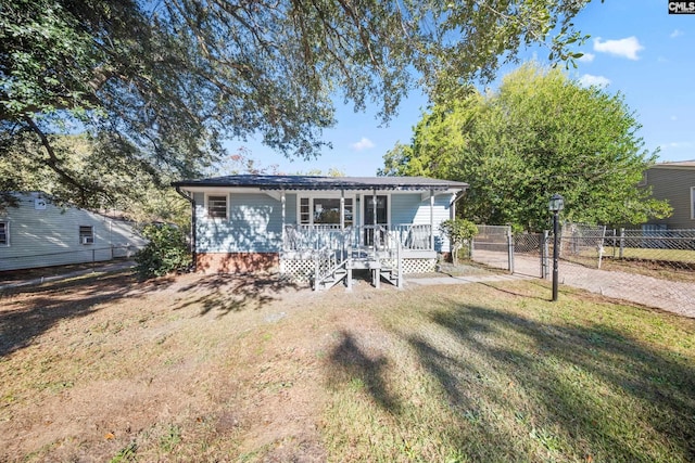 view of front of home featuring covered porch and a front lawn