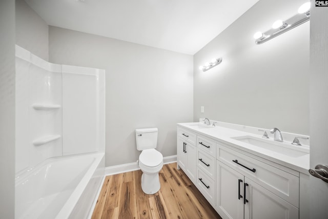 bathroom featuring a shower, hardwood / wood-style floors, toilet, and vanity