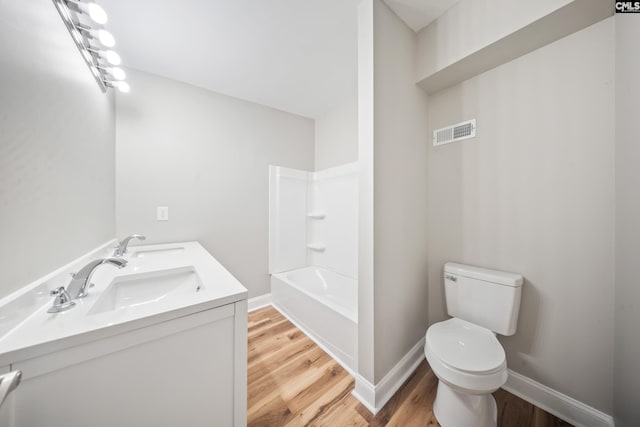 full bathroom with toilet, vanity, shower / washtub combination, and hardwood / wood-style flooring